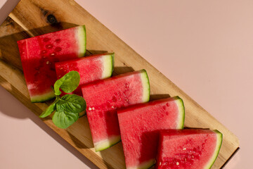 Slices of vibrant watermelon bask on rustic board, summer solstice celebration, sweet refreshment, invoking watermelon thumps and picnics