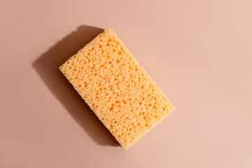 Yellow sponge resting on serene beige backdrop, evoking Zen cleaning rituals and quirky Lather Day...