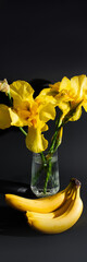 Yellow irises dance above bananas in shadow, evoking Horticultural Day, with a touch of surreal market bounty