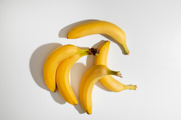 Golden bananas splay elegantly on blank canvas, evoking tropical sunlit whispers, perfect for...