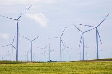 Whispering blades dance on verdant fields, evoking Windmill Day reverie, kinetic embrace of Earth Day's eco-conscious tapestry