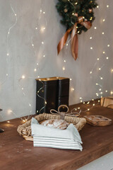 Home New Year's kitchen interior. Decorations with garlands and a Christmas wreath. Cozy atmosphere of a home holiday, loft-style interior design, Scandinavian style.