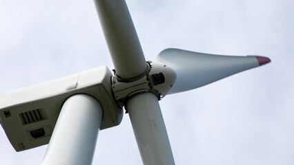 Giant wind turbine blades pirouette gracefully against the azure, symbolizing Earth Day and curious technoscape celebrations © fotoworld