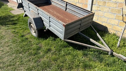 Rustic trailer basks in sunshine, whispering tales of harvest festivals and countryside escapades,...