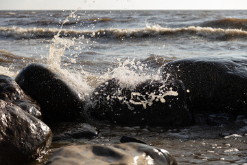 Ocean Waves Splashing Against Coastal Rocks Under Bright Daylight
