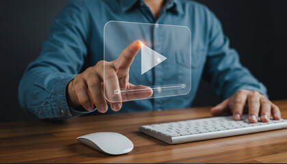 Digital Media Streaming Concept – Man Pressing Virtual Play Button on Transparent Screen While Sitting at Desk with Keyboard and Mouse – Online Video Playback and Technology Interface