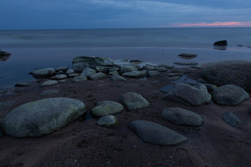Serene Coastal View with Rocks and Calm Seascape at Sunset