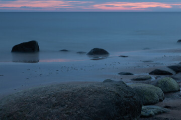 Serene Coastal View with Rocks and Calm Seascape at Sunset