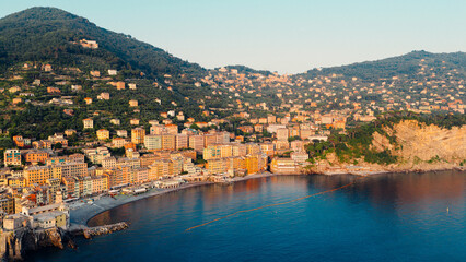 Camogli, liguria, italy: colorful buildings overlooking the mediterranean sea at sunset