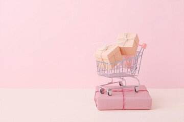 Miniature Shopping Cart with Peach Gift Boxes on Pink Background