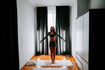 Young woman practices yoga at home for health and wellness in a calm indoor environment
