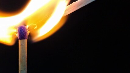 burning candle flame on black background, dark moody atmosphere 