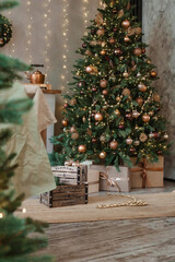 Home New Year's interior. Christmas tree with gifts, decorated with garlands in the kitchen. Cozy...