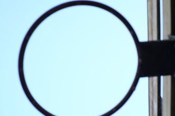 Sky framed by a rustic iron circle in soft focus, suggesting reflection