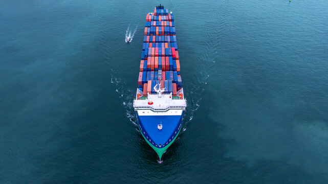 Aerial view from drone, Container ship or cargo shipping business logistic import and export freight transportation by container ship in open sea, Container loading cargo freight ship boat. - Powered by Adobe