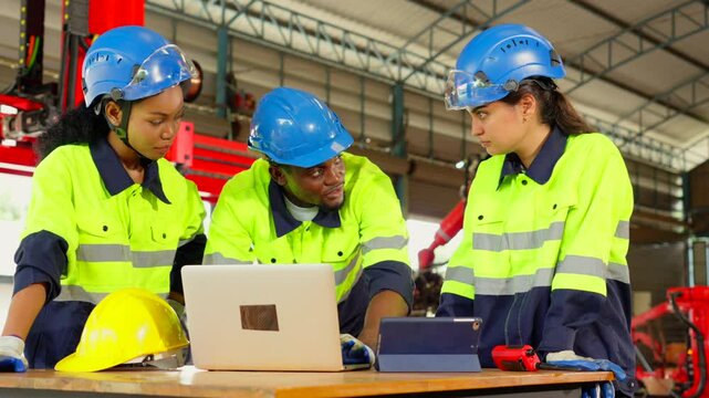 Workers or engineers meeting and talking about work and project in the robot factory