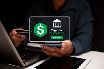 A person completes a successful online payment using a credit card and smartphone near a laptop.
