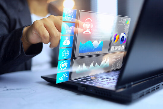 Ai analytics concept with businessman working on laptop computer screen and pointing on artificial intelligence assistance to analyze marketing data and summarize chart format for digital marketing