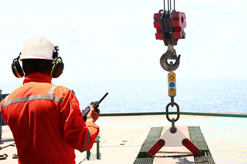 Technician monitor and command by radio to operator on job site in oil and gas industry, Worker in oil and gas industry contact to operation team to check condition of the machine, Maintenance work.