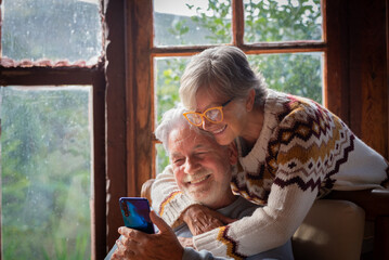 Senior couple in their 70s spending calm and quality time together in a cozy mountain chalet. A...