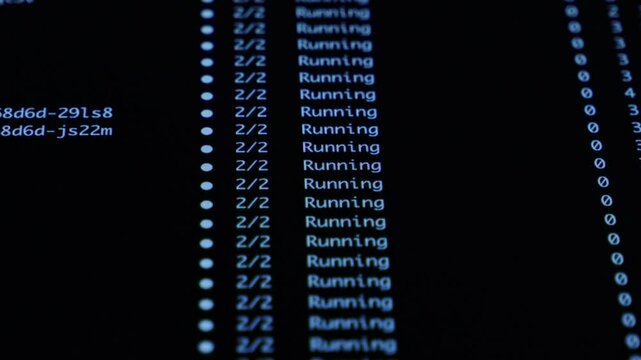 Close-up dark monitor displaying Running and ContainerCreating statuses, illustrating active software development, backend operations, or IT management