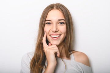 Portrait of teenage girl in casual t-shirt on light background in studio.