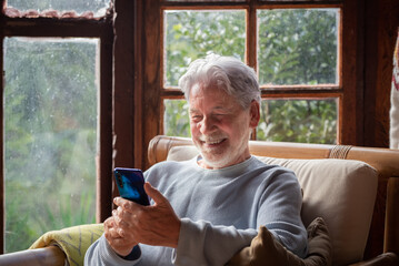 Senior couple in their 70s spending calm and quality time together in a cozy mountain chalet. A...