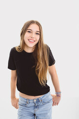 Fototapeta premium Portrait of teenage girl in casual black t-shirt on light background in studio.