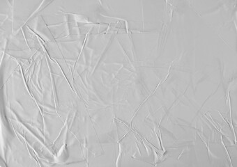 white wrinkled poster template, mockup of glued paper isolated on black background and texture