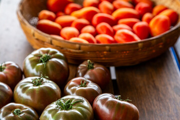Cherokee Purple and Napoli Paste tomatoes on wooden table