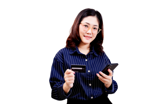 Asian young beautiful woman wearing glasses holds a credit card in one hand and a smartphone in the other, smiling confidently.