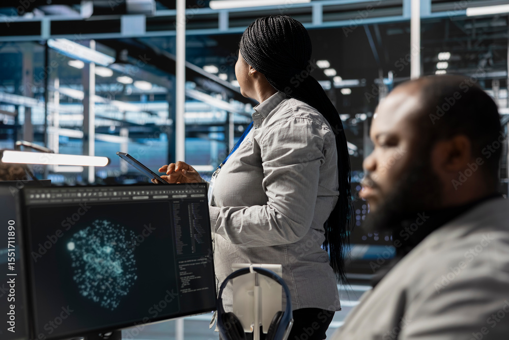 Poster data center employee monitoring system performance using pc, identifying malfunctions. african ameri