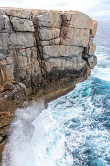 The Southern Ocean breaking on the entrance to The Gap in the Torndirrup National Park near Albany in the Shire of Denmark, Great Southern region of Western Australia, WA, Australia.