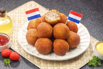 Bitterballen is the name of a type of food in the Netherlands. Bitterballen taste similar to croquettes, but are small round shapes about 3 to 4 cm