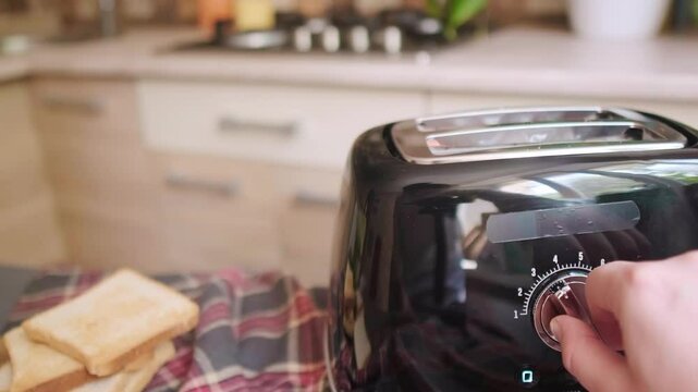 Woman turns on toaster to toast bread for a delicious homemade sandwich easy breakfast preparation in cozy kitchen atmosphere