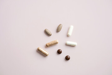 Various Pills and Capsules on Light Background. Daily Vitamins and Supplements for Healthy...