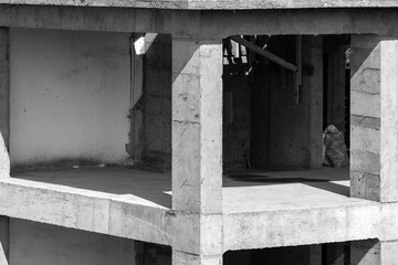 A grayscale photograph showing an incomplete concrete building