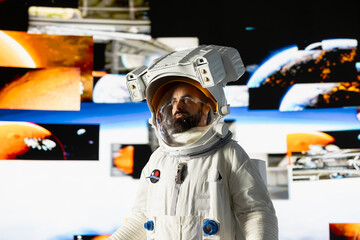 Male astronaut in a space suit floats in orbit above Earth, symbolizing the journey of humanity...