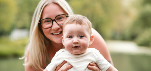 Happy family on a summer meadow. little girl child baby daughter with mother