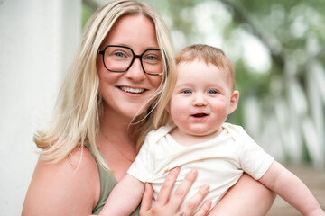 Happy family on a summer meadow. little girl child baby daughter with mother