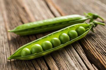 Summer harvest still life featuring ripe pea pods on a natural wooden surface