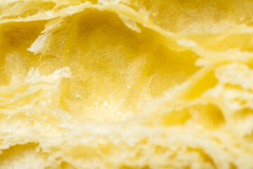 Closeup view of a freshly baked croissant sliced. Food texture background