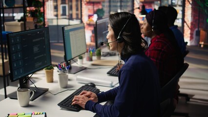 Experienced call center employee listening to customer inquiries and complaints. Asian senior customer service representative assisting customers with issues related to products or services, camera B