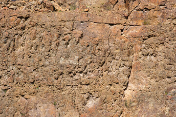 Textured rock surface with geological patterns. Showcasing textures and natural patterns. Background to geology and outdoor exploration.