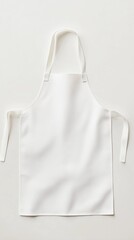 Plain White Apron with Thin Straps Laid Out on Pure White Background Ideal for Cooking, Baking, Culinary Arts, or Kitchen Use for Food Preparation