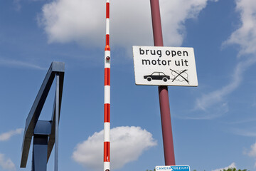 A Dutch sign at a bridge crossing instructs drivers to turn off engines when the bridge is open,...