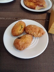 cups of tea and coffee with assorted pastries on a café table. cozy breakfast or snack setup in a casual dining setting.