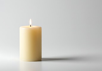 Lit candle with a bright flame isolated on a white background