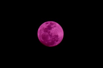 a purple-color moon at night with black isolated