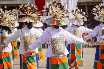 Anjat Tani Dance is a traditional dance of the Dayak Kenyah tribe. This dance symbolizes gratitude for the harvest. showing a typical Dayak woven bag usually called Anjat from behind a woman
